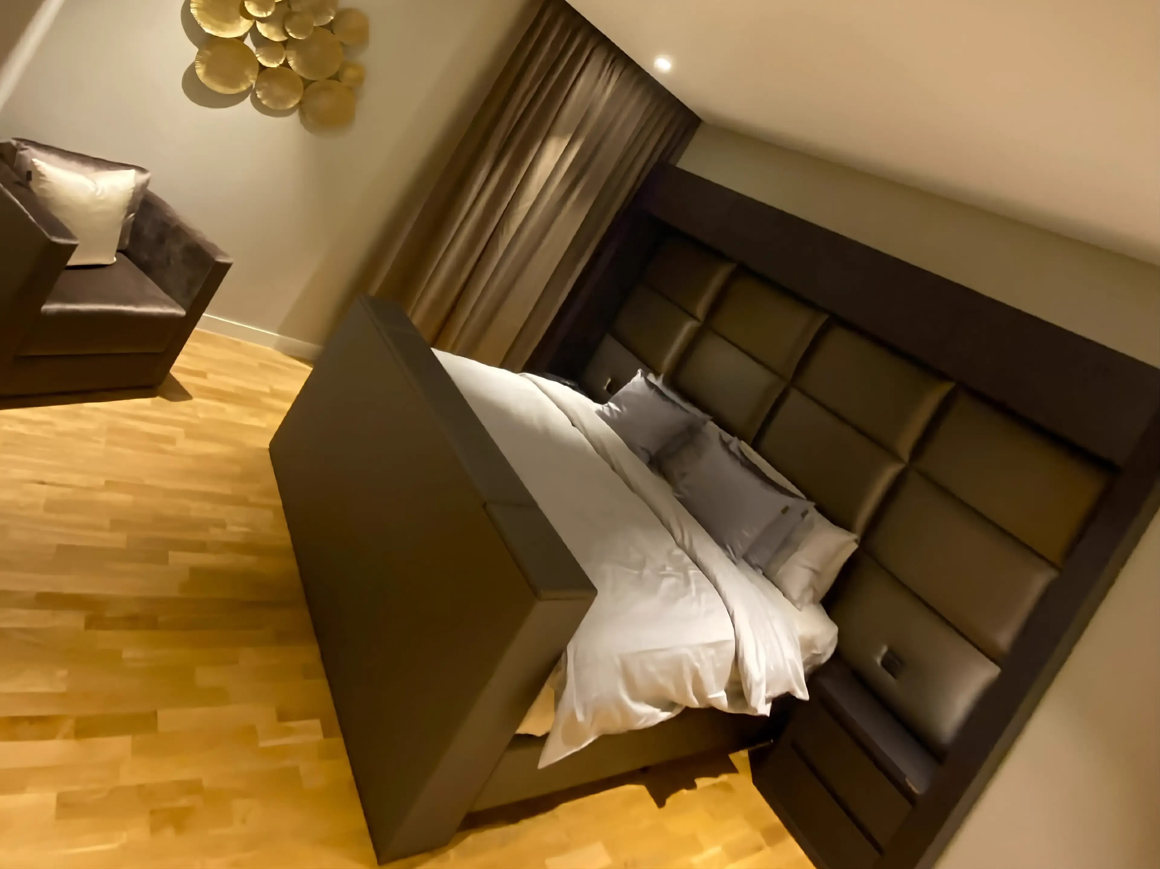 Timber wall panelling and warm lighting in the primary bedroom